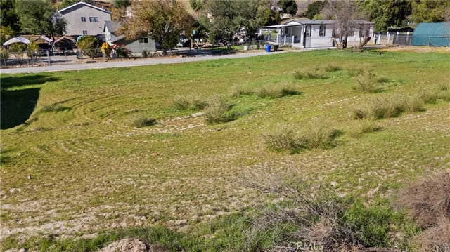 a view of yard with swimming pool and seating area