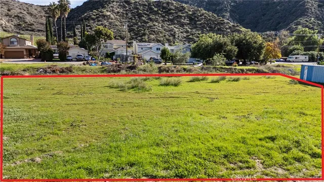 a childrens park with lots of green space and trees