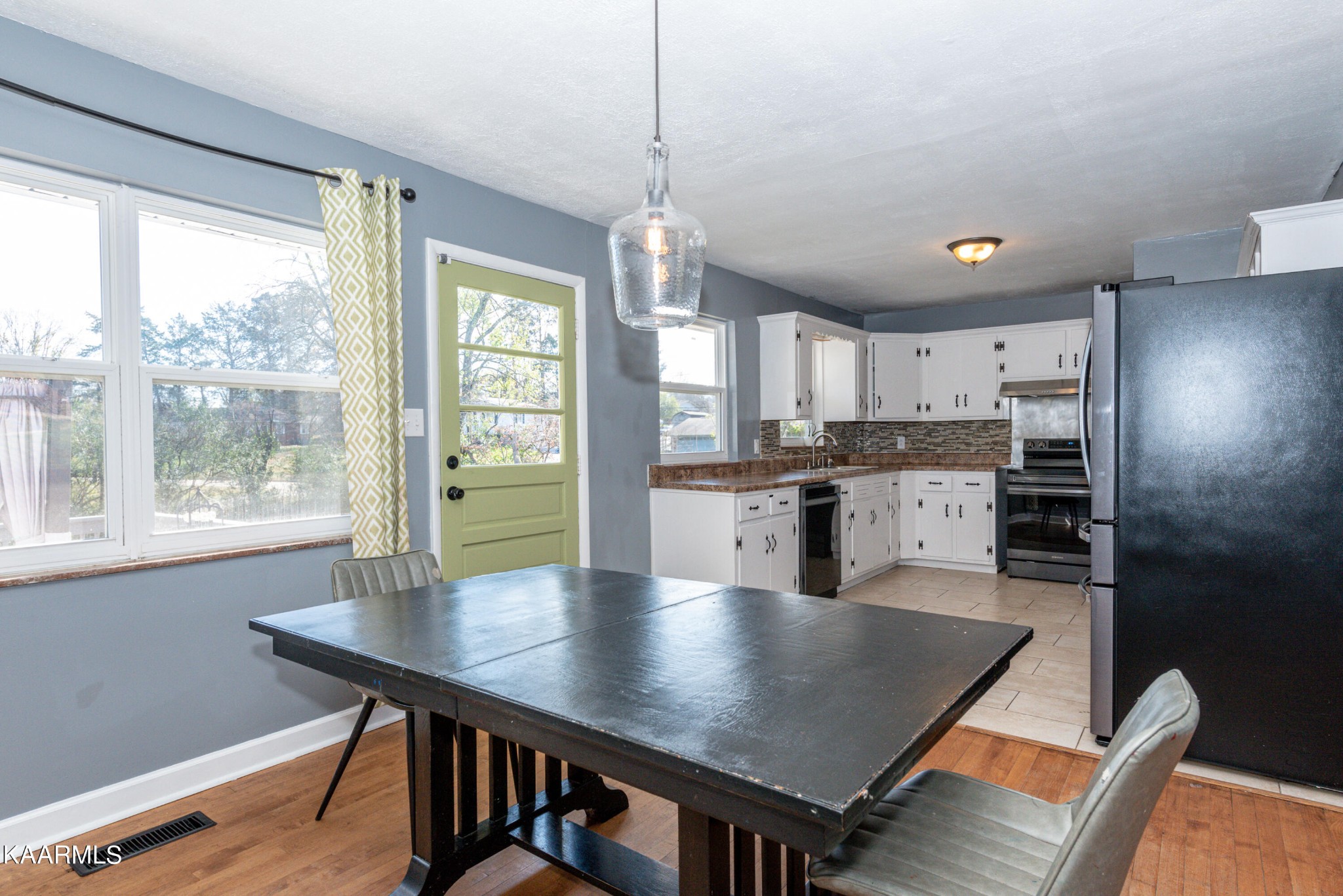 5428 Maywood Road Knoxville, TN 37921 - Photo 7 of 31 a kitchen with kitchen island a wooden floor and white appliances