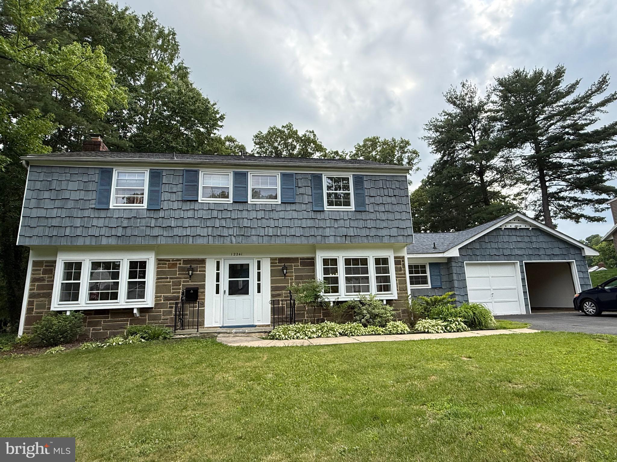 a front view of a house with a garden