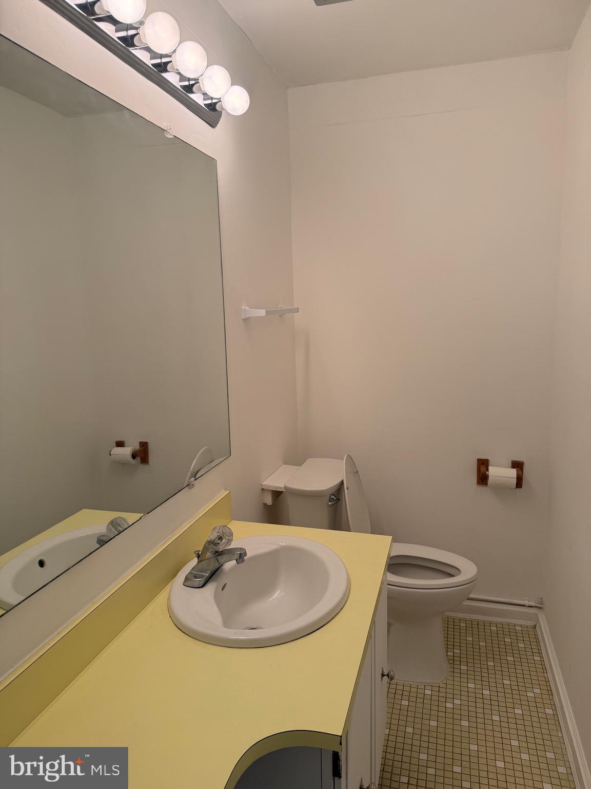 12241 Shadetree Lane Laurel, MD 20708 - Photo 16 of 25 a bathroom with a sink a toilet and a mirror