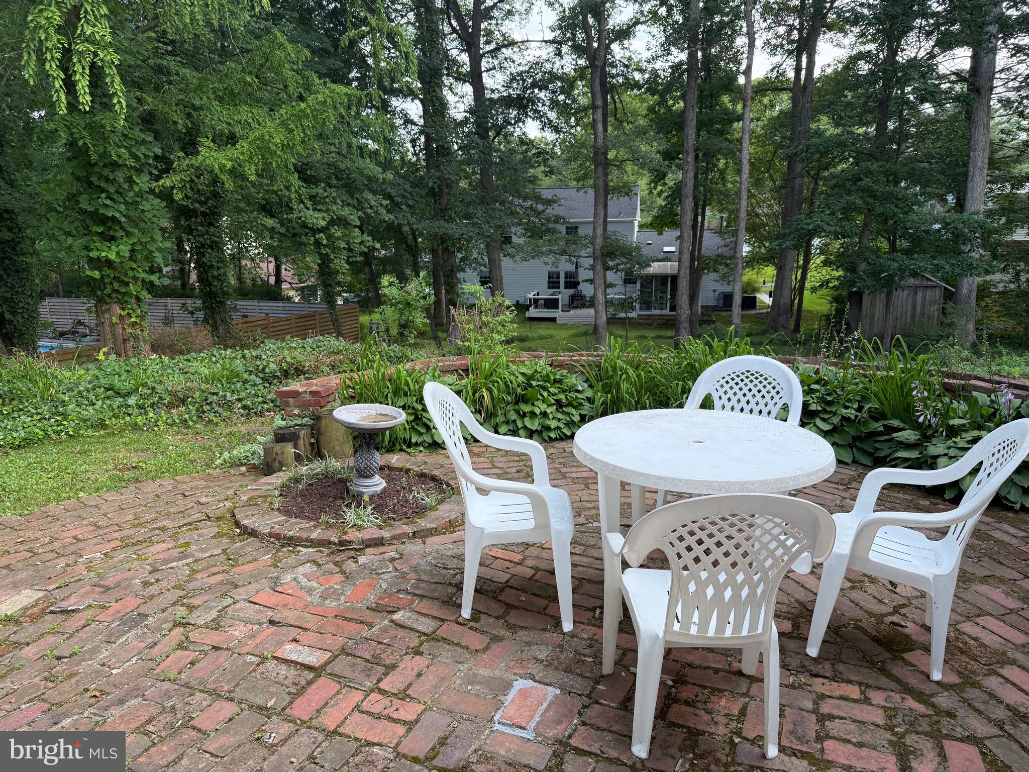 12241 Shadetree Lane Laurel, MD 20708 - Photo 19 of 25 a view of a table and chairs in backyard of the house