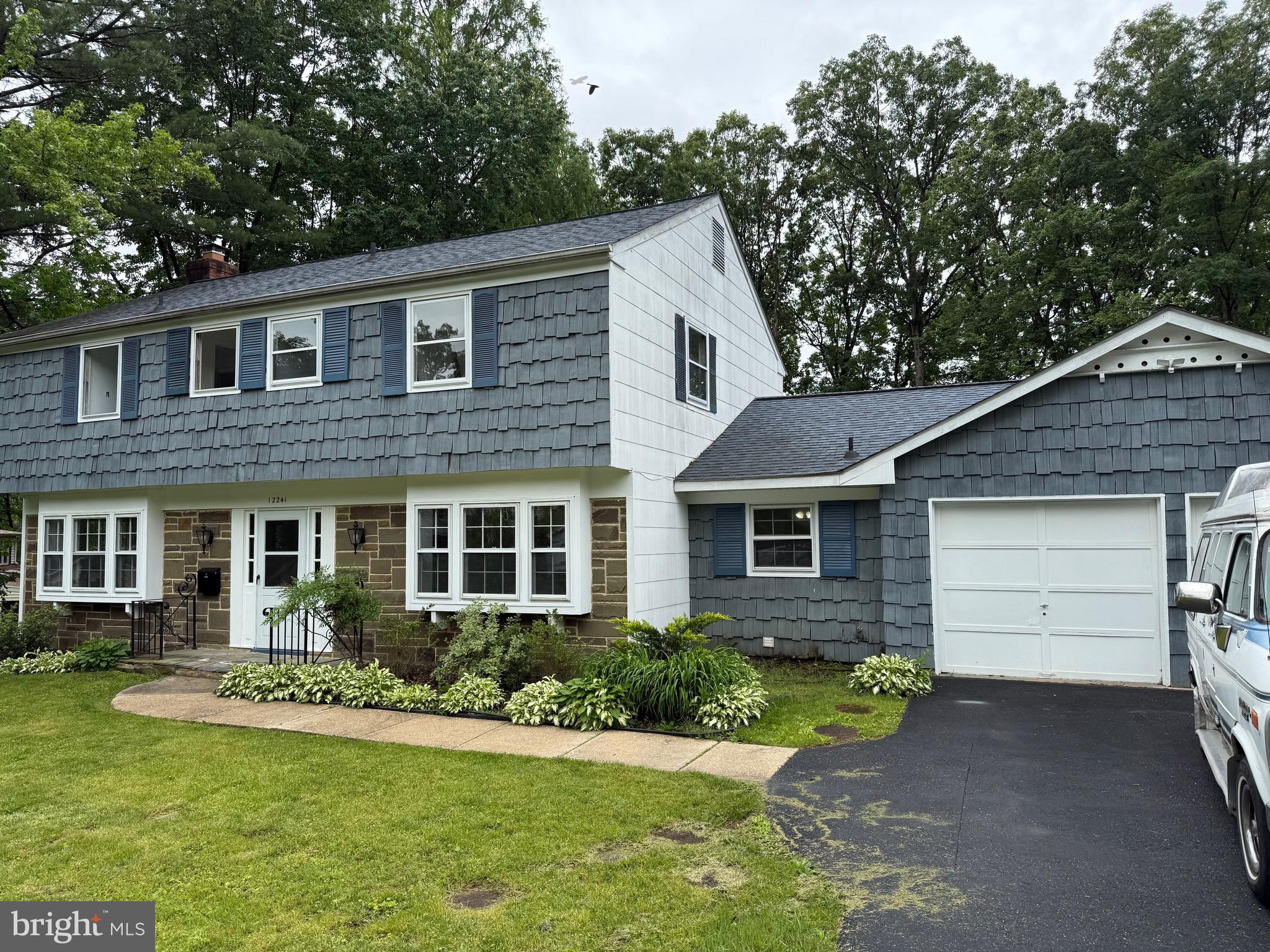 12241 Shadetree Lane Laurel, MD 20708 - Photo 2 of 25 a front view of a house with a yard and garage