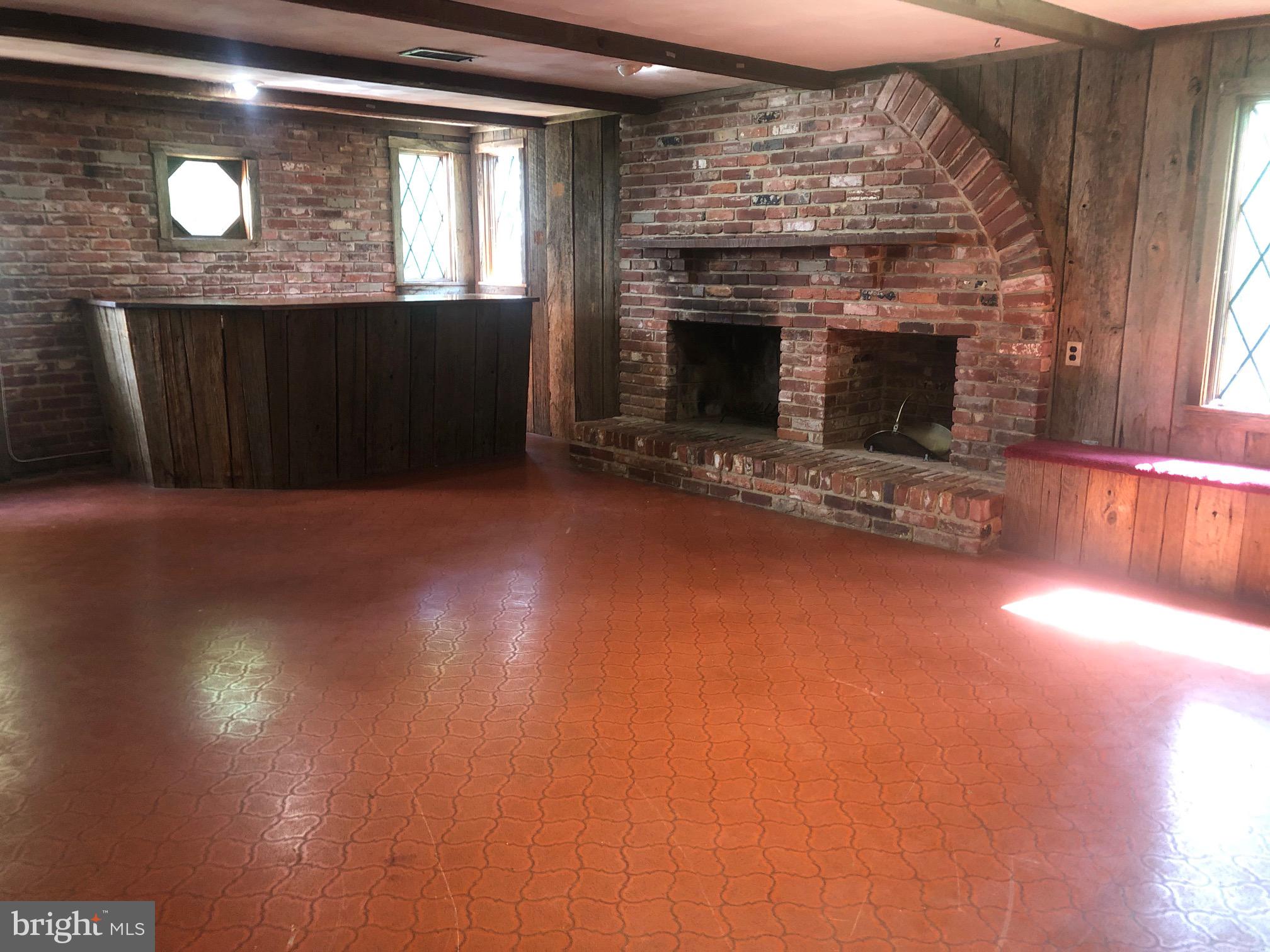 12241 Shadetree Lane Laurel, MD 20708 - Photo 5 of 25 a living room with hard wood floors and a fireplace