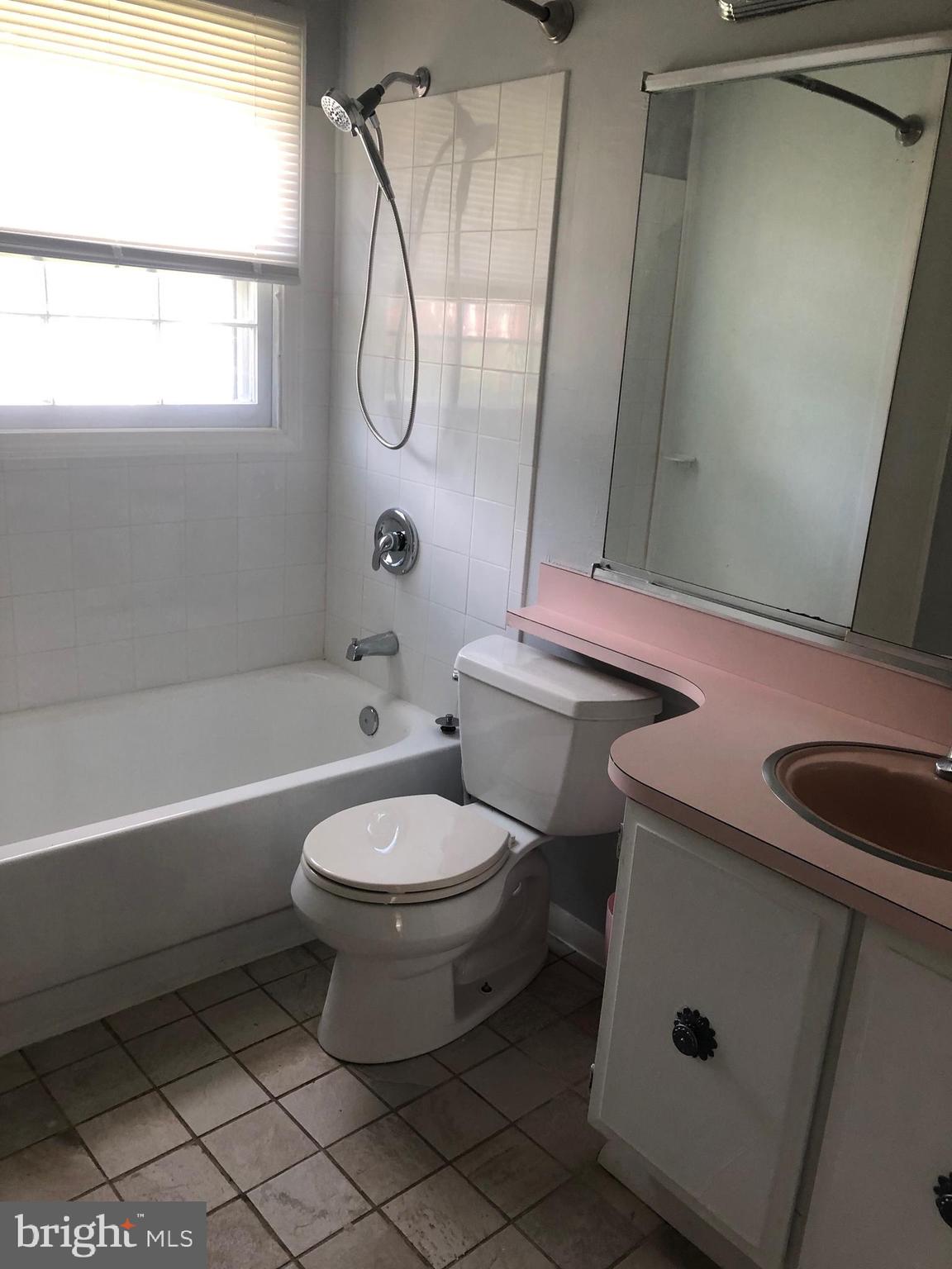 12241 Shadetree Lane Laurel, MD 20708 - Photo 6 of 25 a bathroom with a sink a toilet and a bathtub