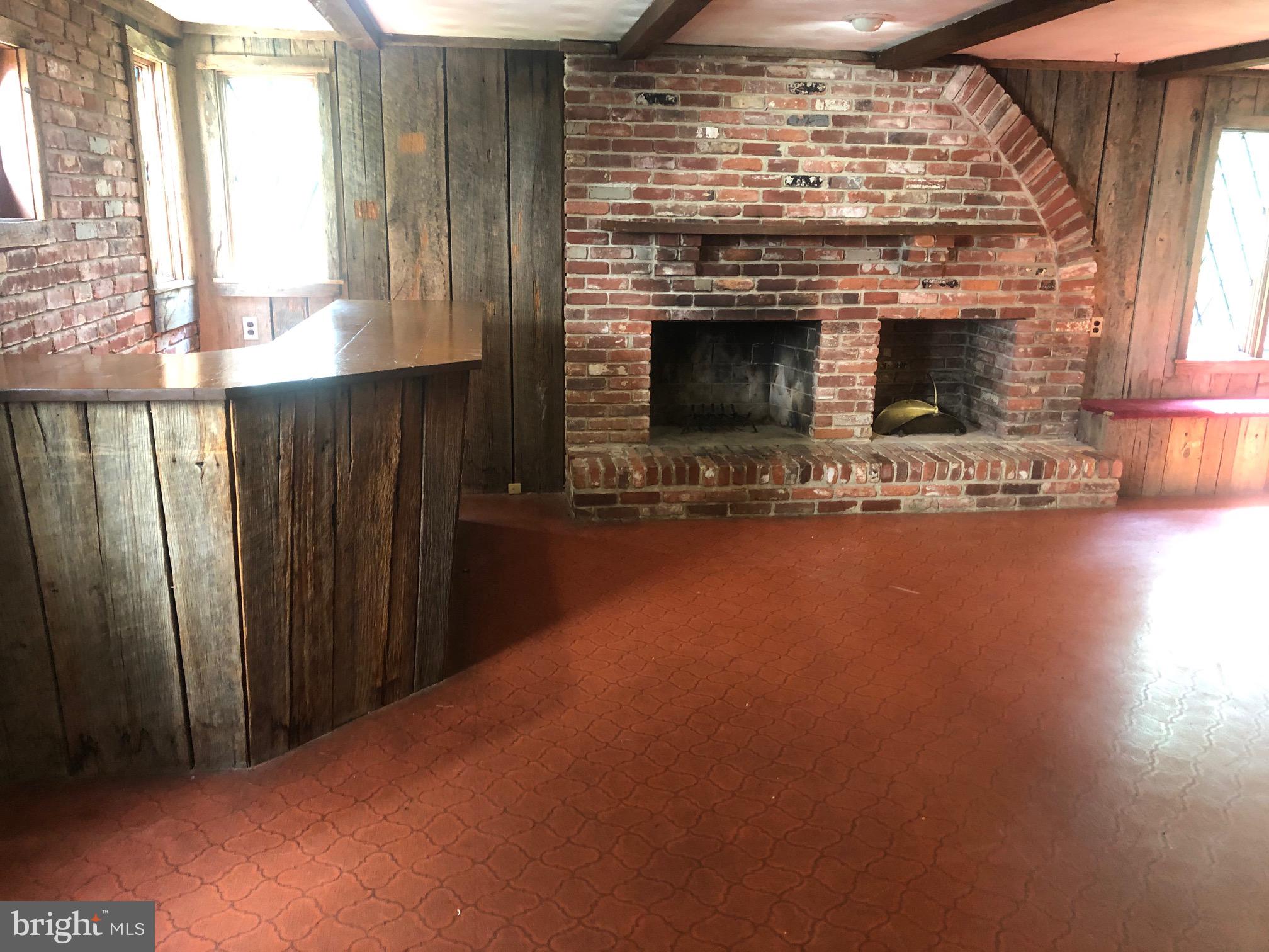 12241 Shadetree Lane Laurel, MD 20708 - Photo 7 of 25 a view of empty room with fireplace and wooden floor
