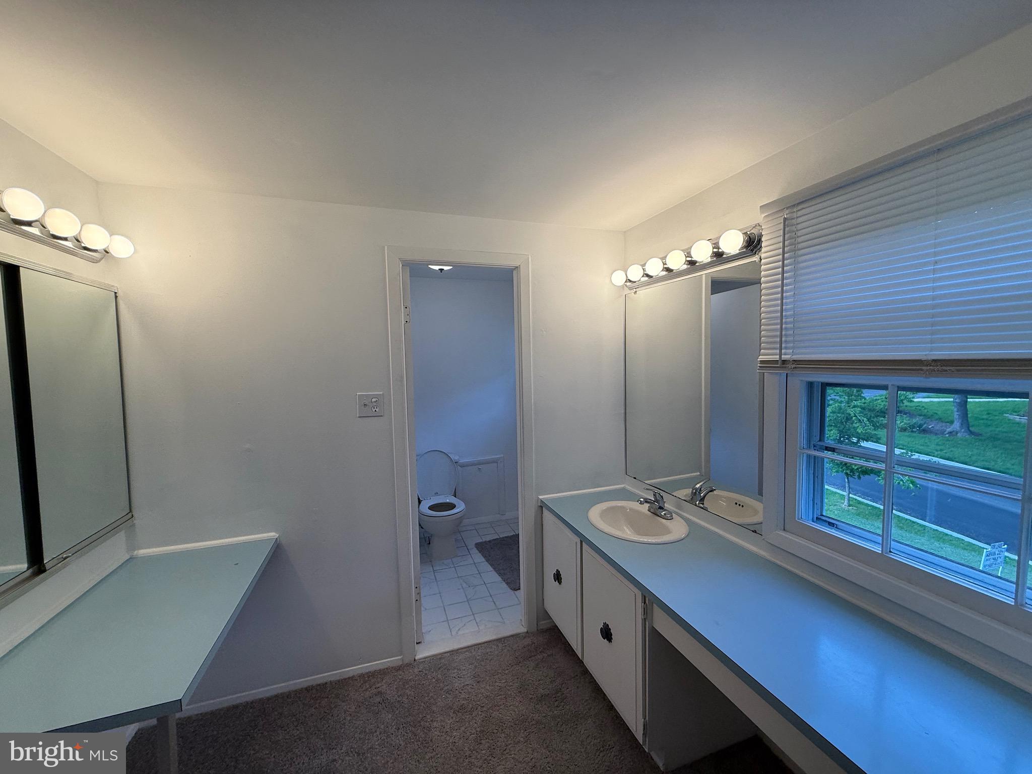 12241 Shadetree Lane Laurel, MD 20708 - Photo 10 of 25 a bathroom with a double vanity sink a mirror and a shower
