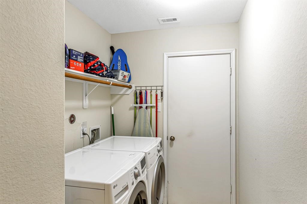 3203 Dale Ridge Trail Houston, TX 77084 - Photo 27 of 33 Functional dedicated laundry room complete with built-in storage shelving and washer/dryer hookups.