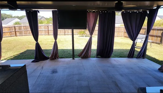 an empty room with large window and front door