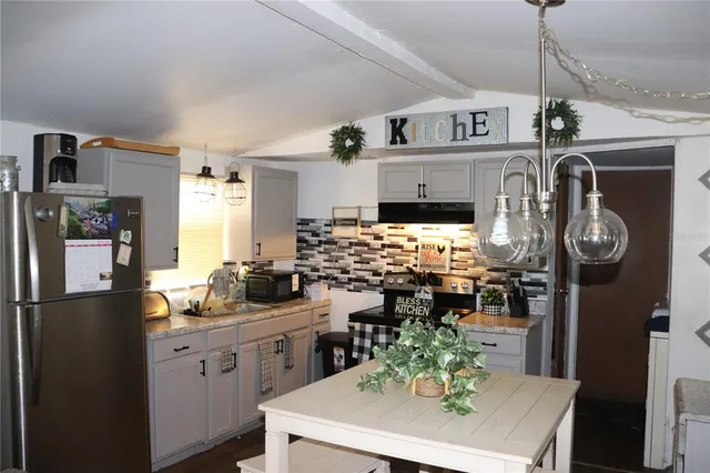 a kitchen with refrigerator and stove