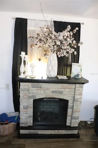 a close view of a fireplace with wooden floor
