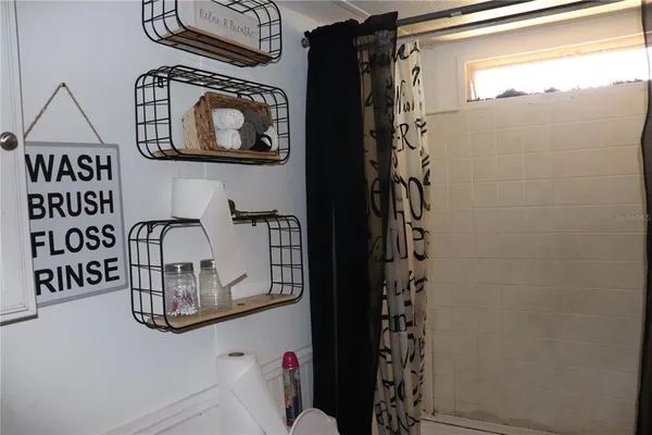 a bathroom with a window and a shower