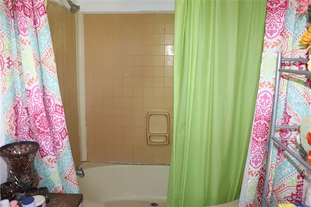 a bathroom with a bathtub and shower curtain