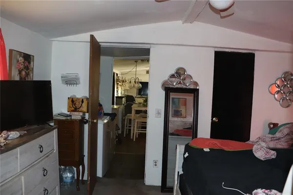 a bedroom with furniture and flat screen tv
