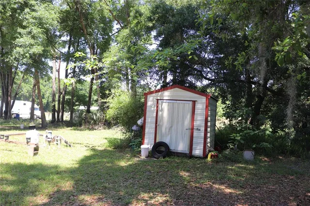a view of a yard with large trees