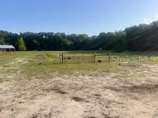 a view of outdoor space with swimming pool and green space