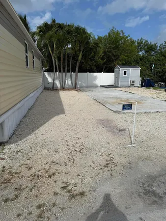 a view of a backyard with a tree
