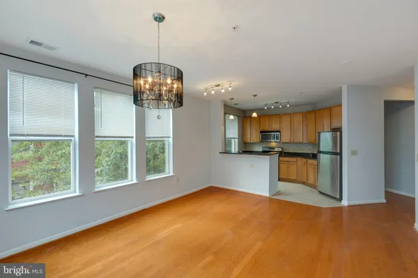 a kitchen with kitchen island a counter top space a sink and appliances