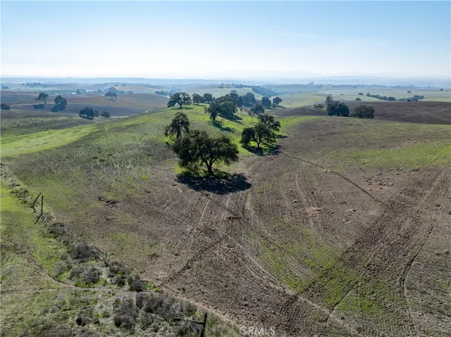 a view of a field with an ocean