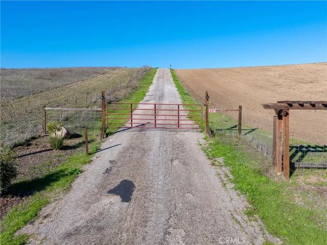 a view of a pathway with a wrought fence