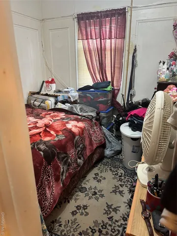 a bed sitting in a bedroom next to a window