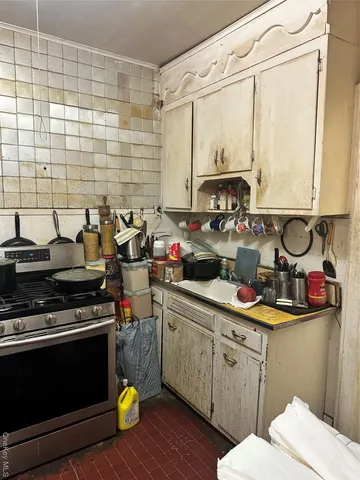 a kitchen with a sink and wooden cabinets