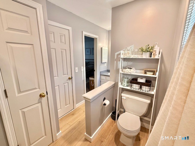 104 Ginger Lane Torrington, CT 06790 - Photo 22 of 33 a bathroom with a toilet a sink and glass door