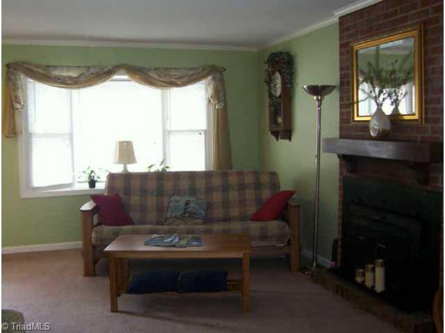 4841 Tower Road, Unit A Greensboro, NC 27410 - Photo 2 of 6 Other. Living Room Complete With Bay Window and Fireplace With Woodstove