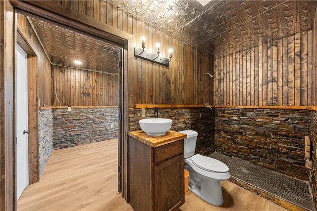 a bathroom with a toilet a sink and shower