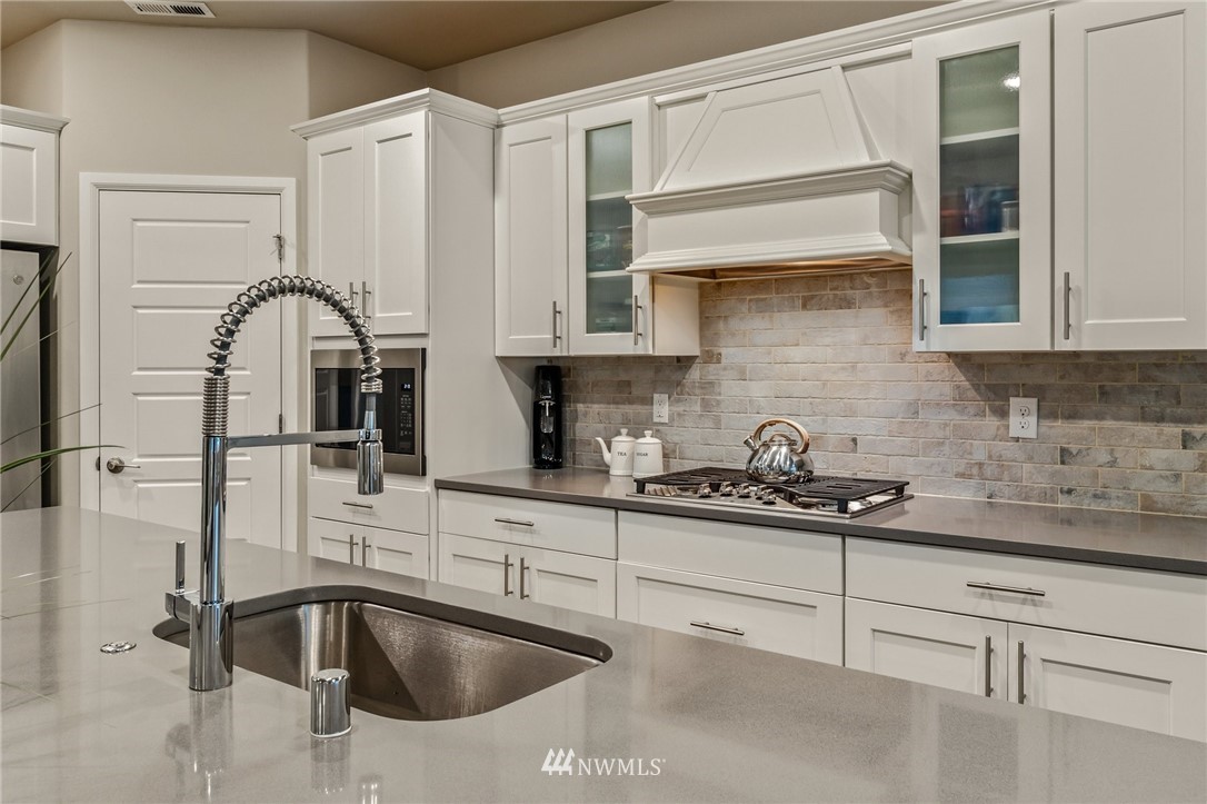 117 178th Street Southeast Bothell, WA 98012 - Photo 15 of 40 a kitchen with stainless steel appliances granite countertop a sink and cabinets