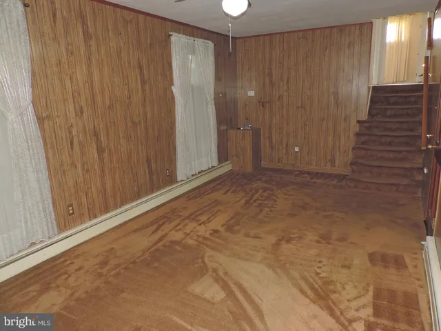 a view of an empty room with wooden walls