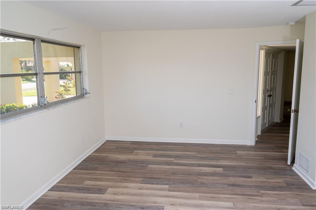 5654 Eichen Circle Fort Myers, FL 33919 - Photo 15 of 47 Unfurnished room with wood finished floors