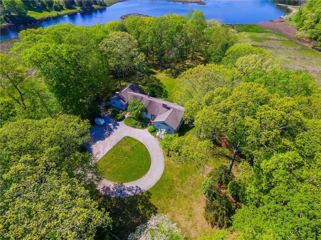 a aerial view of a house with swimming pool and large trees