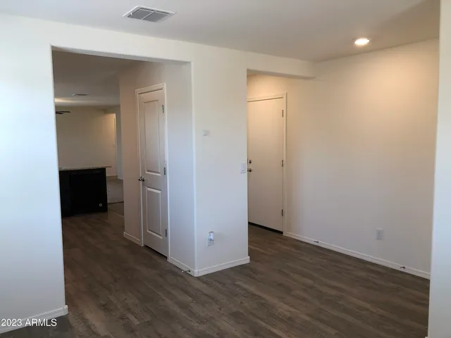 an empty room with wooden floor and closet