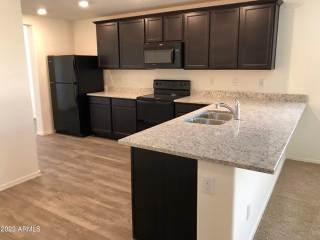 a kitchen with kitchen island a cabinets and refrigerator