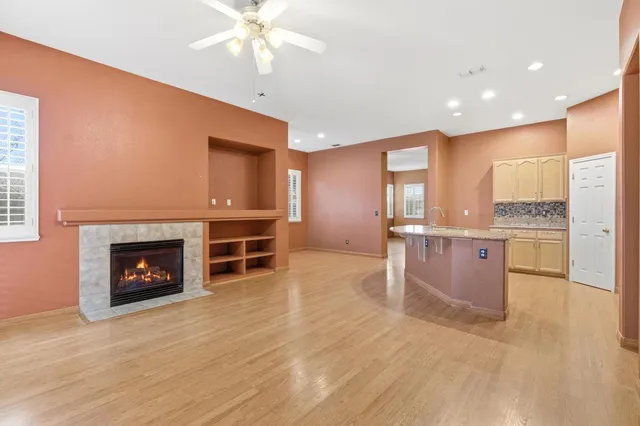 a view of a kitchen with a sink and a fireplace