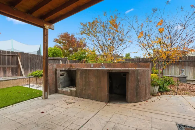 a couple of table and chair in backyard of house