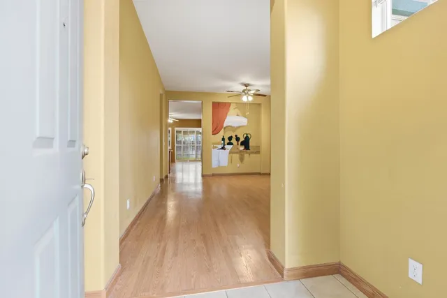 a view of a hallway with wooden floor