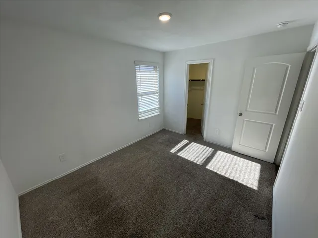 a view of an empty room with glass door
