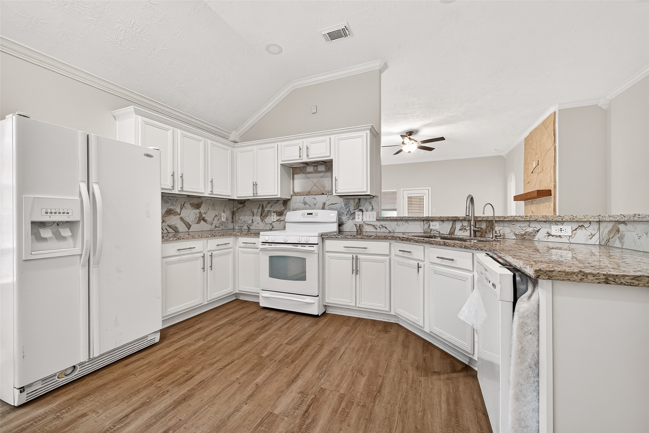 5517 Autumn Ash Lane Rosharon, TX 77583 - Photo 19 of 50 a kitchen with granite countertop white cabinets and white appliances