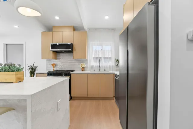 a stove top oven sitting inside of a kitchen