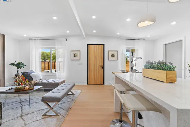 a spacious bedroom with a bed and a painting on the wall