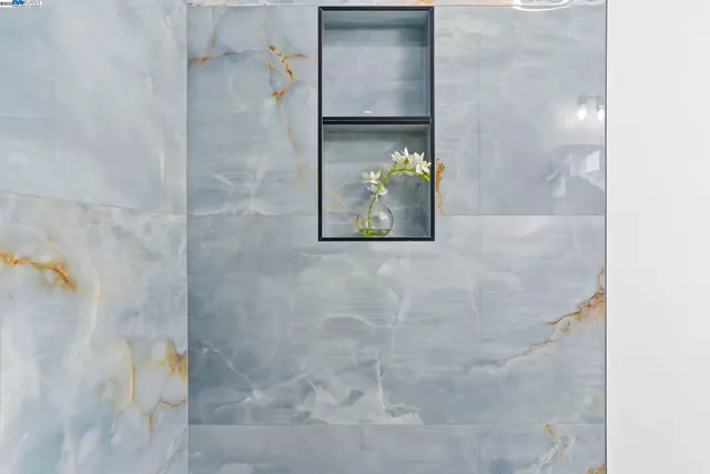 a bathroom with a granite countertop sink a toilet and a mirror