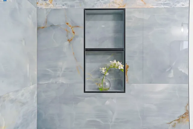 a bathroom with a sink a mirror and a shower