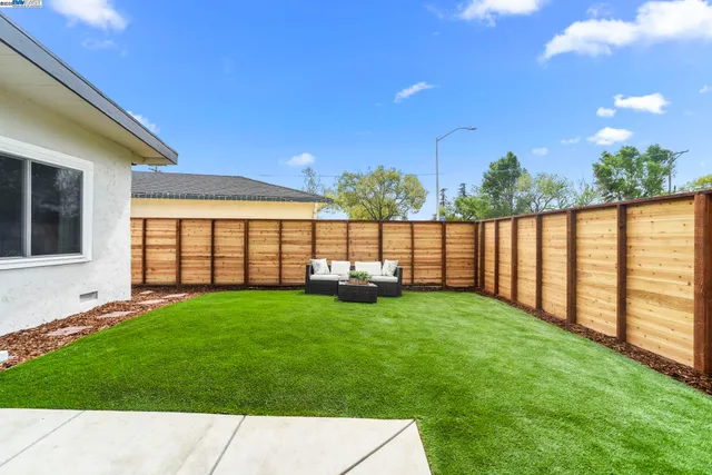 a kitchen with a table chairs refrigerator and microwave