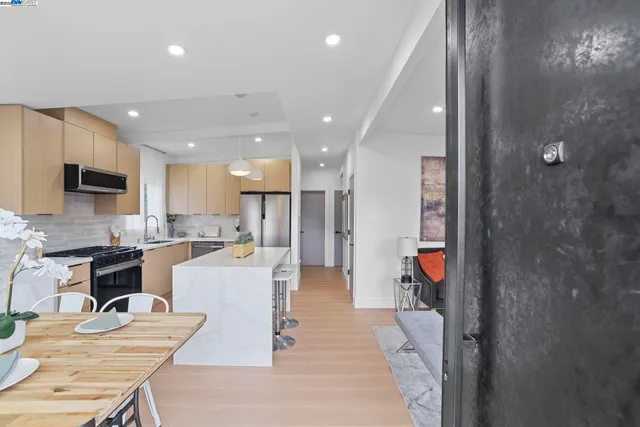 a kitchen with stainless steel appliances granite countertop a stove a refrigerator and a sink