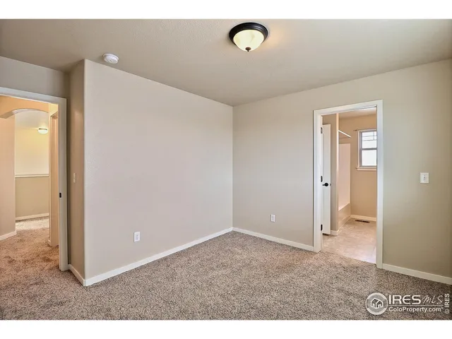 a bathroom with a sink a toilet a mirror and a window