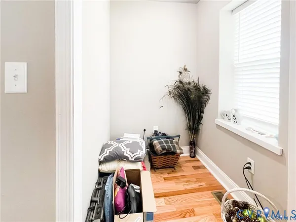 a kitchen with stainless steel appliances granite countertop a sink a stove a refrigerator cabinets and chairs