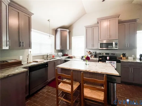 a bathroom with a granite countertop toilet sink and mirror
