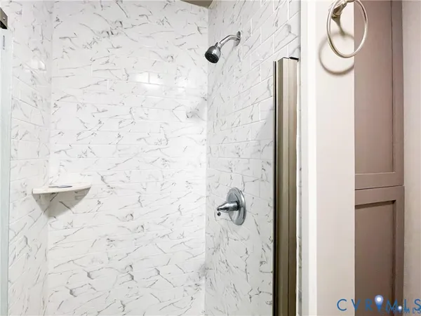 a bedroom with a bed and a large mirror with the dresser